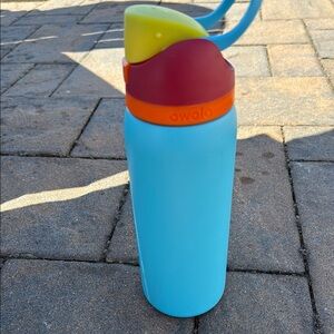 Owala Blue Water Bottle with Red and Yellow Lid